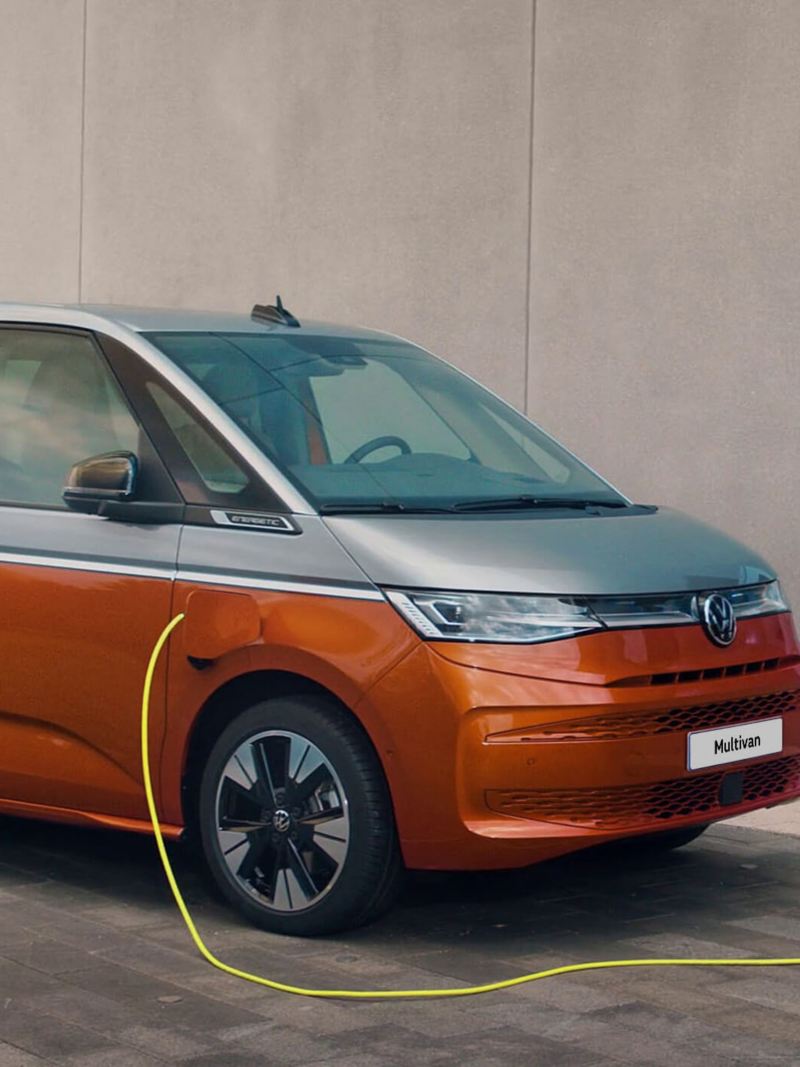 A VW Multivan plugged into charger