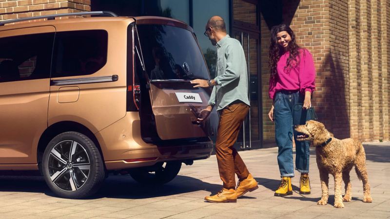 person opening the boot of the new caddy