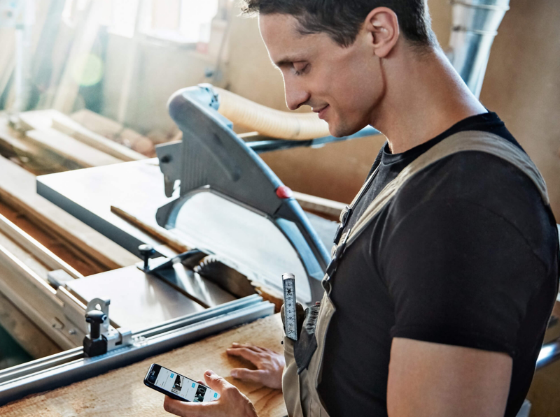 A worker glancing at his phone