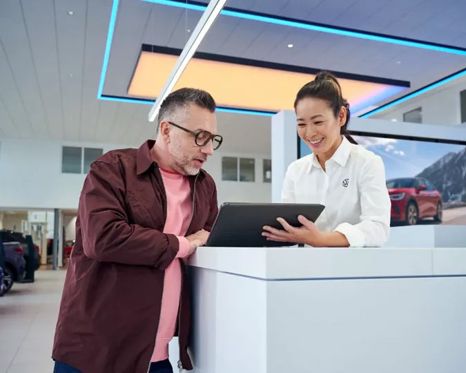 a man talking to a dealership worker