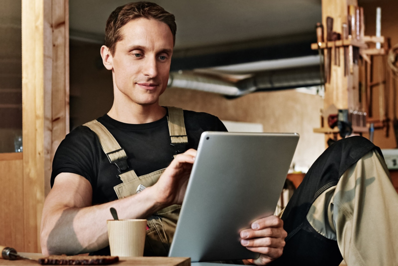 A member of VW Van Centre staff looking at a tablet screen.