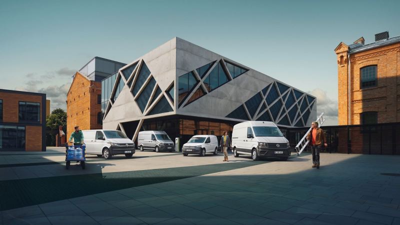 Przedsiębiorcy przed samochodami dostawczymi Volkswagen