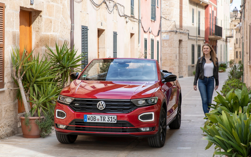 Frau läuft am T-Roc Cabrio vorbei