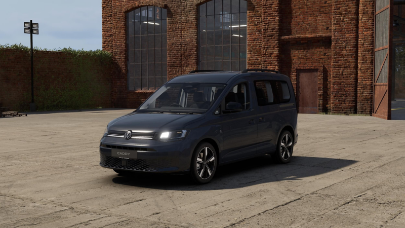 side view of a used VW Caddy outside a warehouse