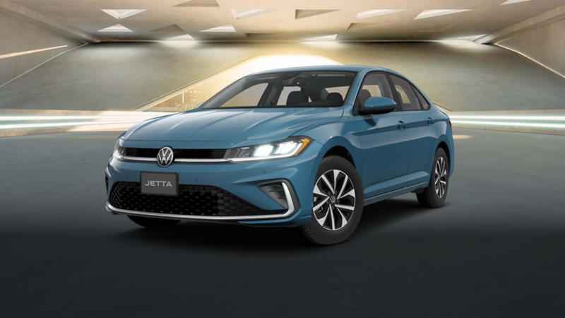 Volkswagen Jetta 2025 en color azul, dentro de un edificio moderno con ventilas de forma triangular. 