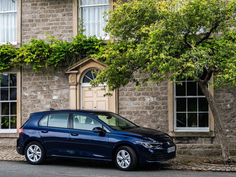 Blue Golf 8 Life parked in front of a house