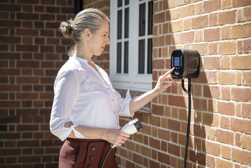 Woman operating an Ohme charging point