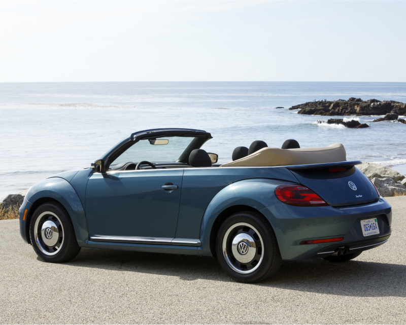 VW Beetle convertible near beach.
