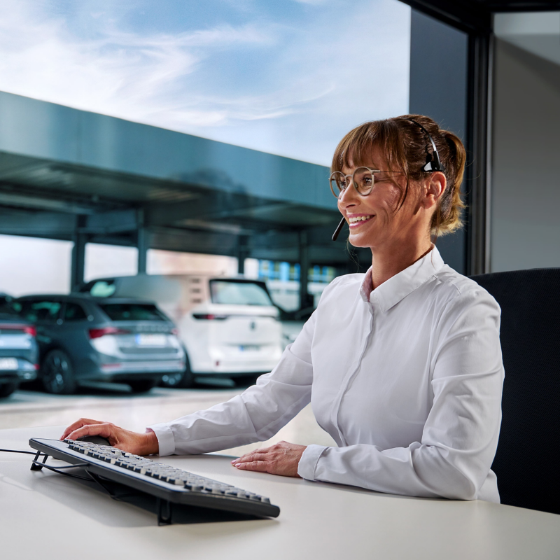 A woman with a headset on and a monitor in front of her