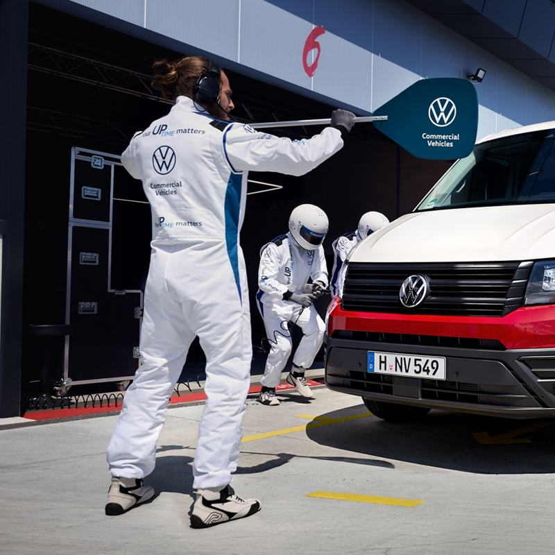 Servicekräfte beim Boxenstopp eines Volkswagen Nutzfahrzeugs. 
