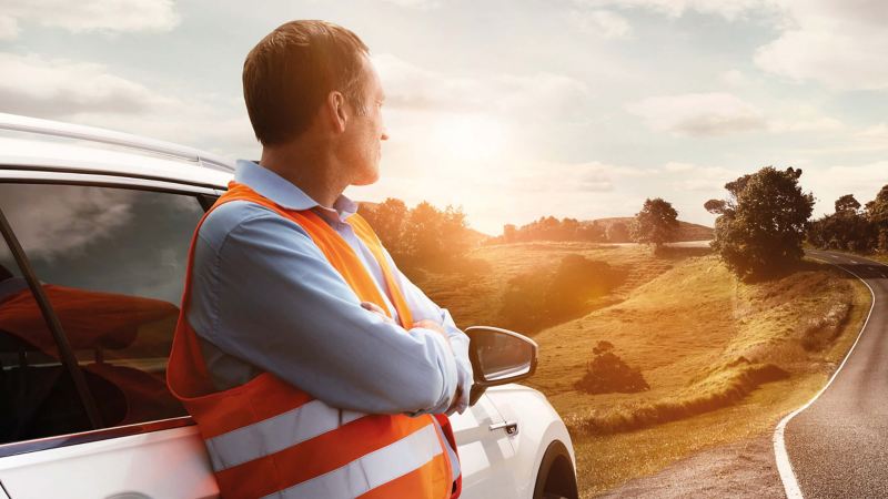 Volkswagen repair engineer, looking out across a valley along a road