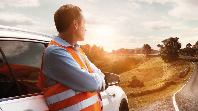 Volkswagen repair engineer, looking out across a valley along a road