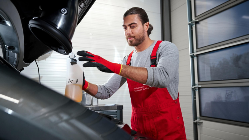 VW technician discussing servicing with a customer.