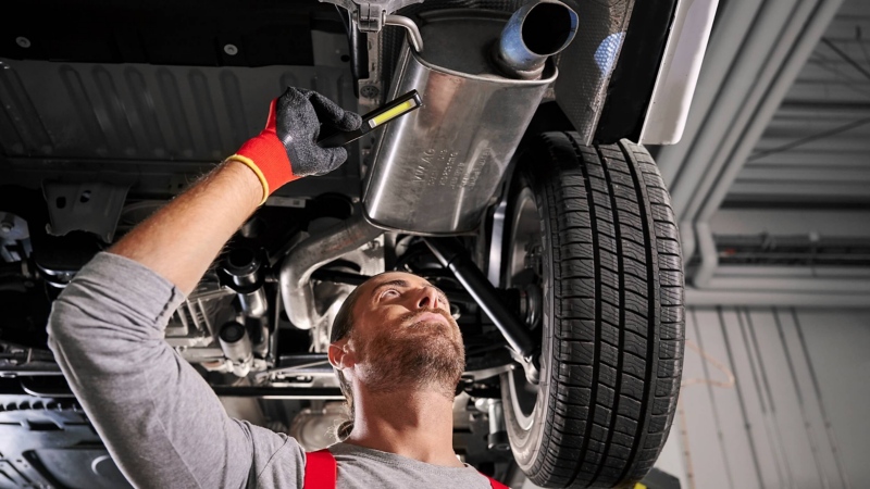 A VW technician checking a vehicle