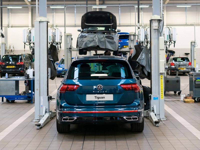 rear view of a blue VW Tiguan parked in a workshop