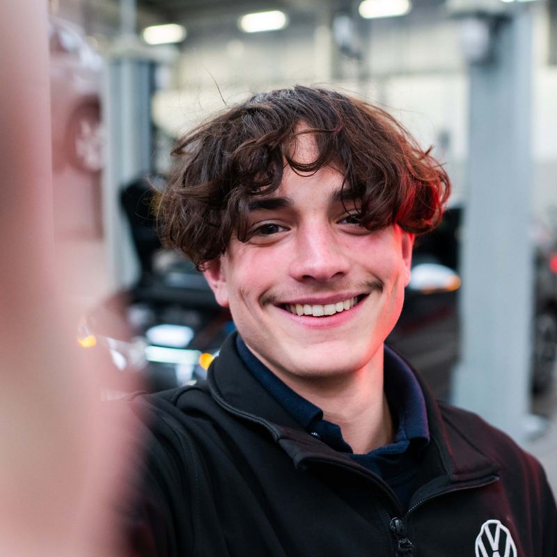A selfie of a VW technician in a workshop
