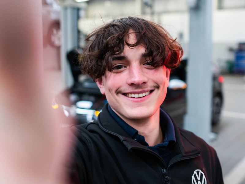 A selfie of a VW technician in a workshop