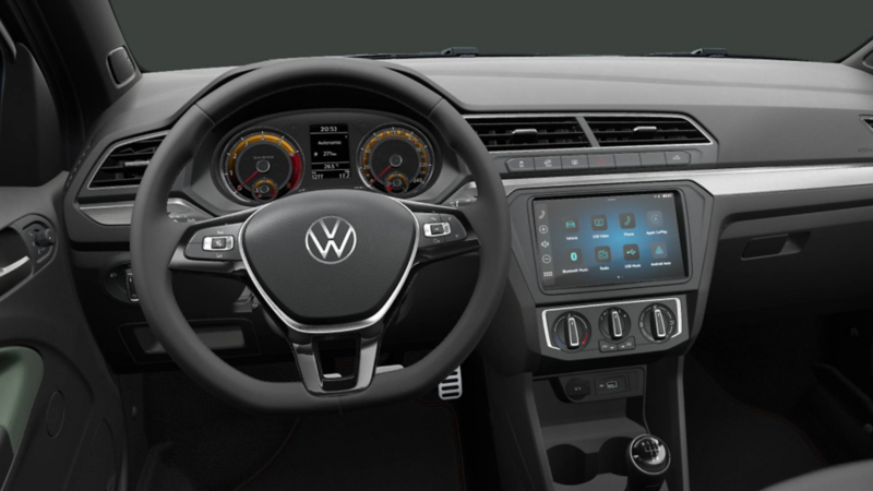 Interior de Nuevo Saveiro Extreme 2024, con volante, pantalla touch, botones de aire acondicionado y ventilas. 