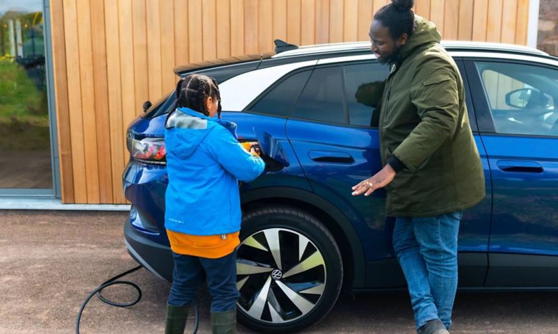 A family charging a Volkswagen car