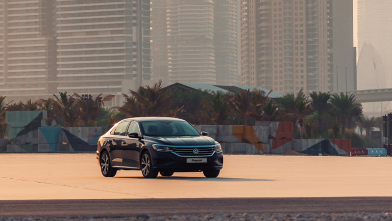 The 2020 Volkswagen Passat parked on a habor overlooking the city of Dubai