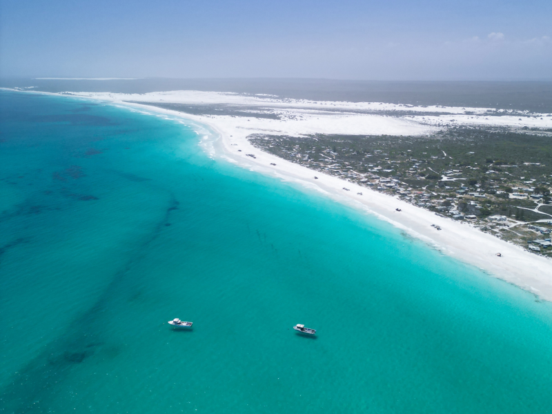 Ariel shot of ocean and white sandy beach