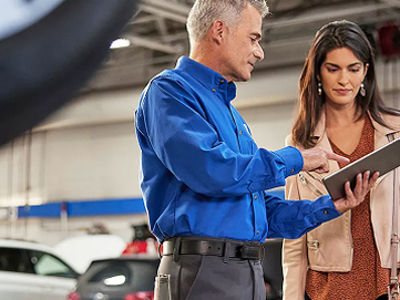 Man working in garage assisting a customer