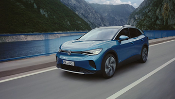 Blue car driving on mountainous road