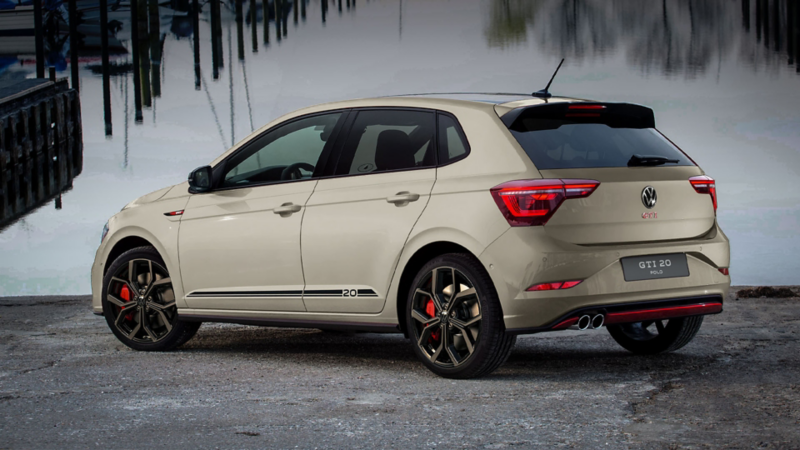 Shot of a white VW Polo GTI with LED headlights switched on, driving in a dark hall under light elements.