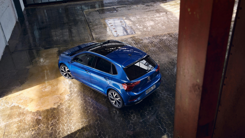 A blue Polo parked diagonally inside a building