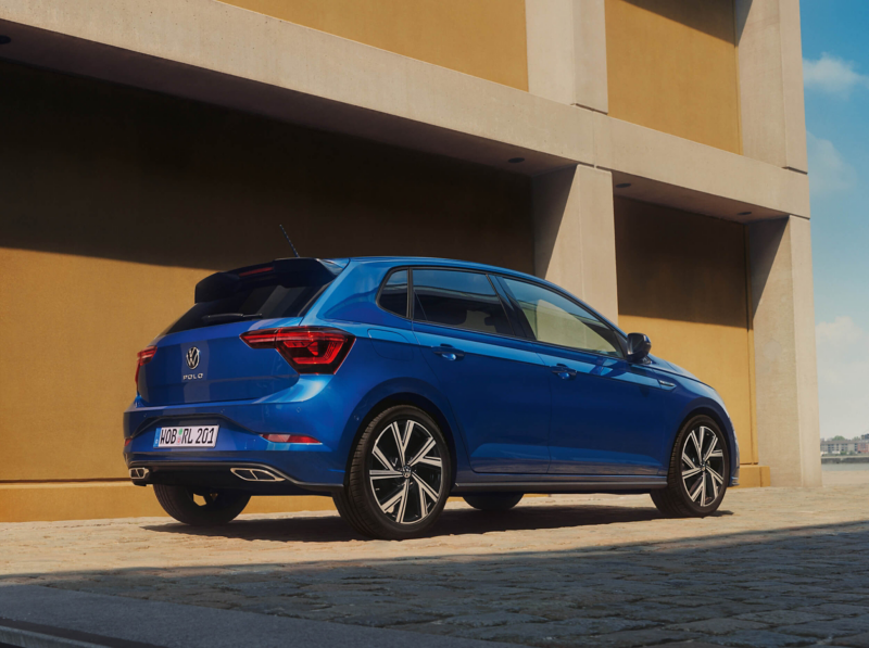 A blue Polo parked outside a building