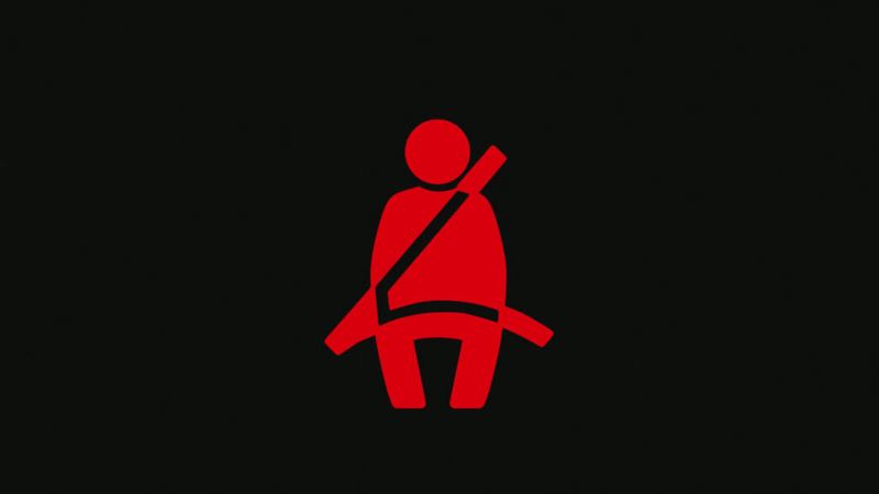 Logo illuminé de la ceinture de sécurité sur fond noir.