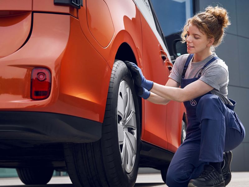 Photo showing a VW technician working on a VW van. 