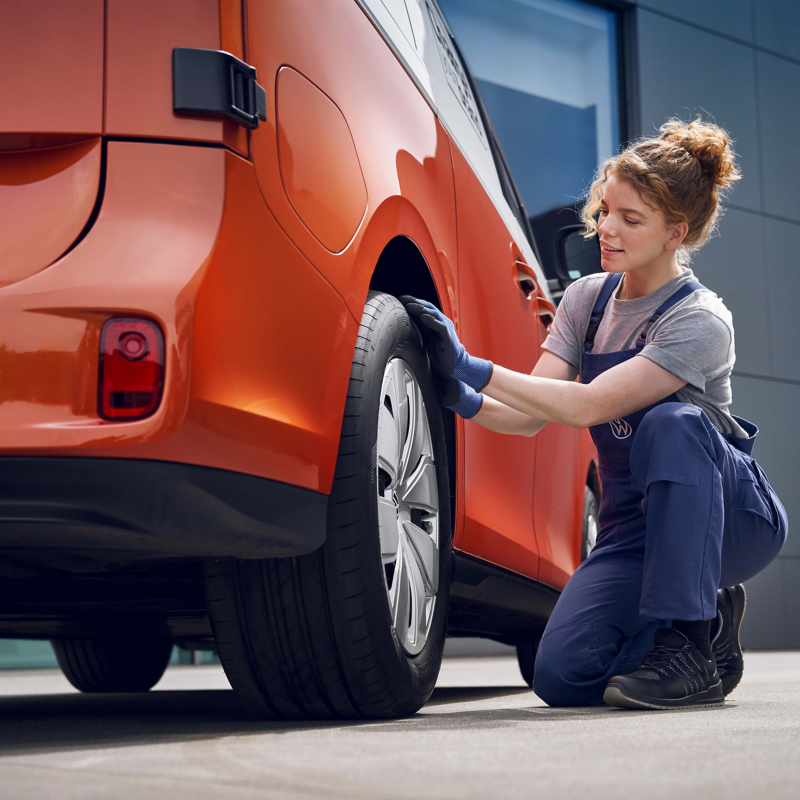 Photo showing a VW technician working on a VW van. 