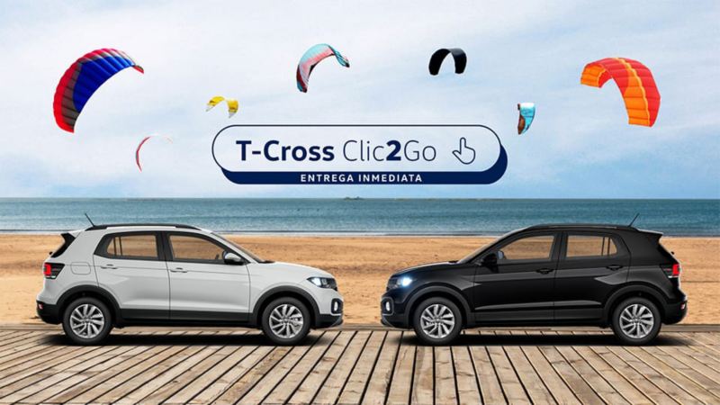 Volkswagen T-Cross blanco y negro de frente en la playa con el logotipo de entrega inmediata