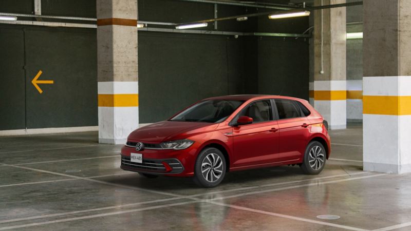 Auto hatchback de Volkswagen color rojo dentro de estacionamiento techado.