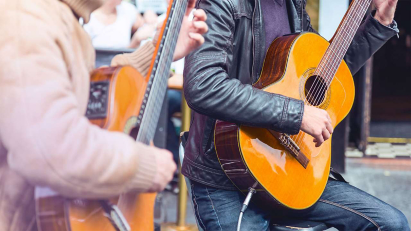 Two musicians playing guitar