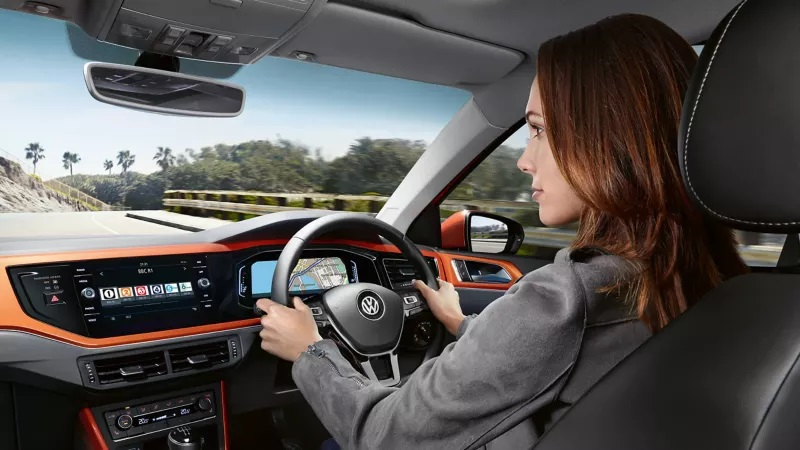 Woman driving a T-Cross on the road