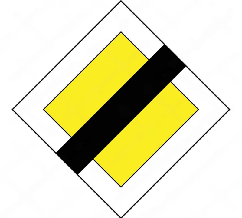Señal de fin de prioridad con un cuadro amarillo y franja color negro.