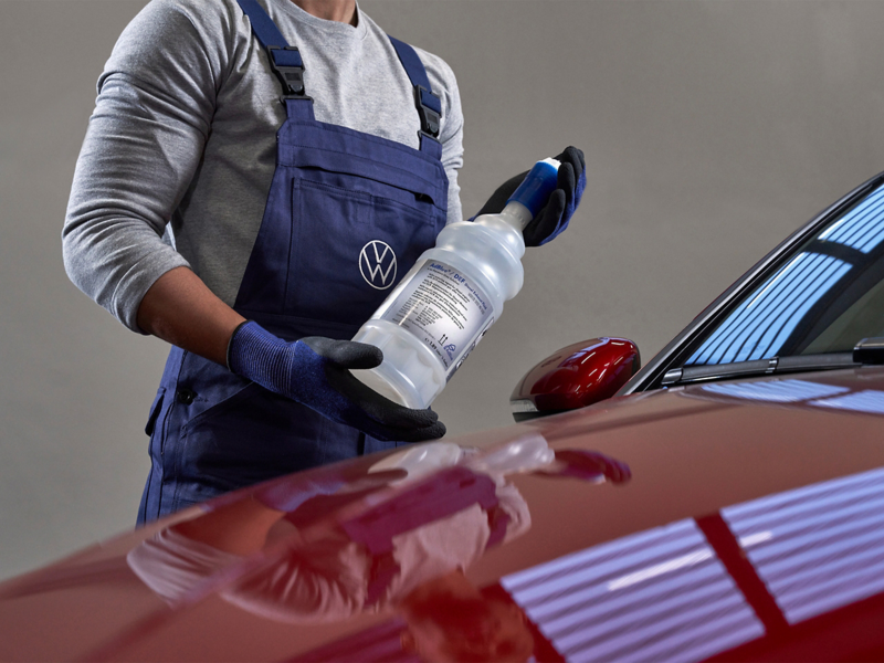 Mechanic replacing Volkswagen AdBlue liquid solution