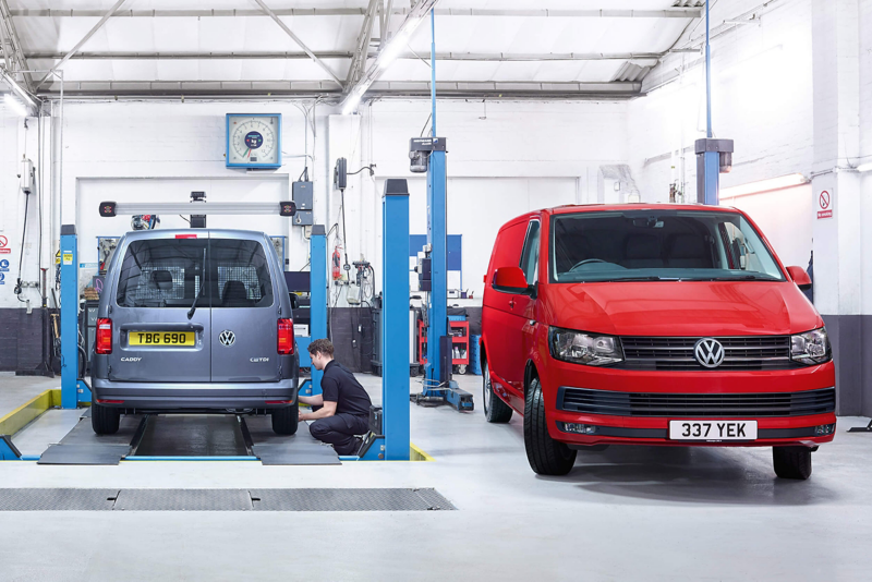 Volkswagen workshop with service bays and red van during vehicle maintenance.
