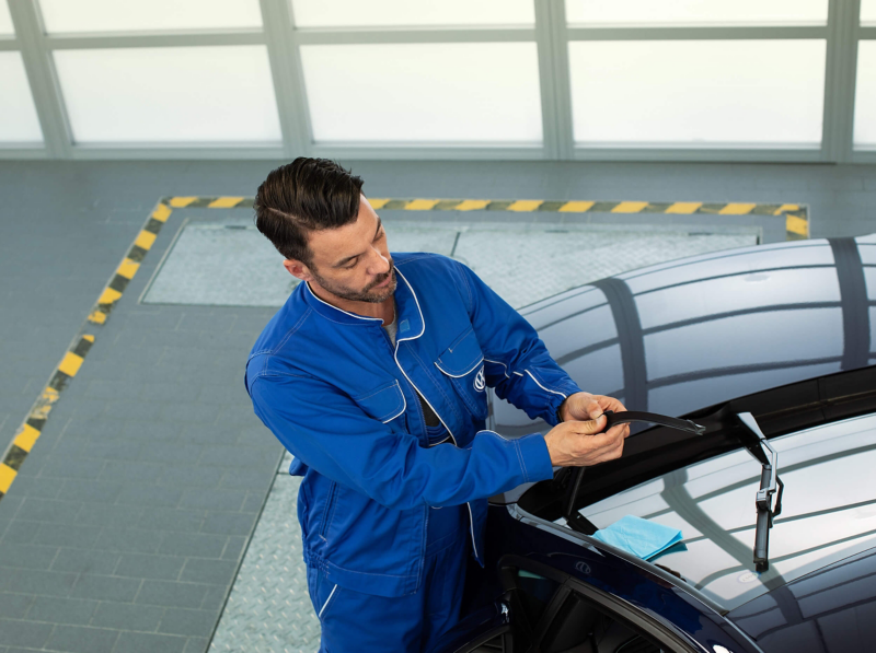 A VW technician fitting wiper blades