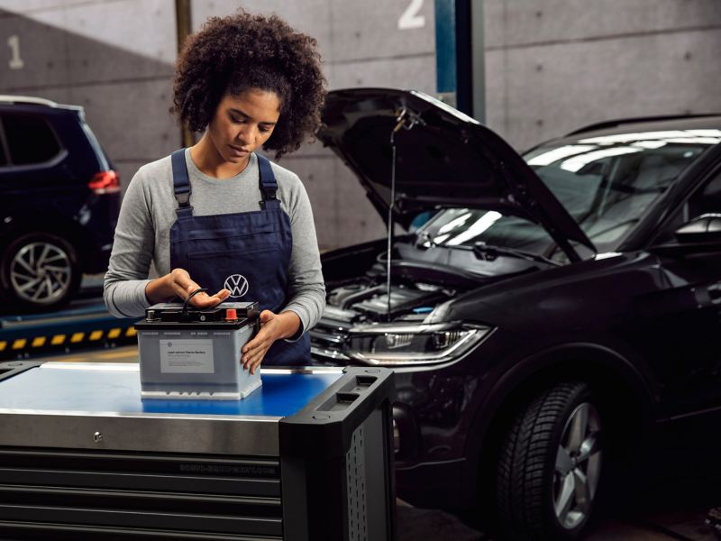 A mechanic working on a battery