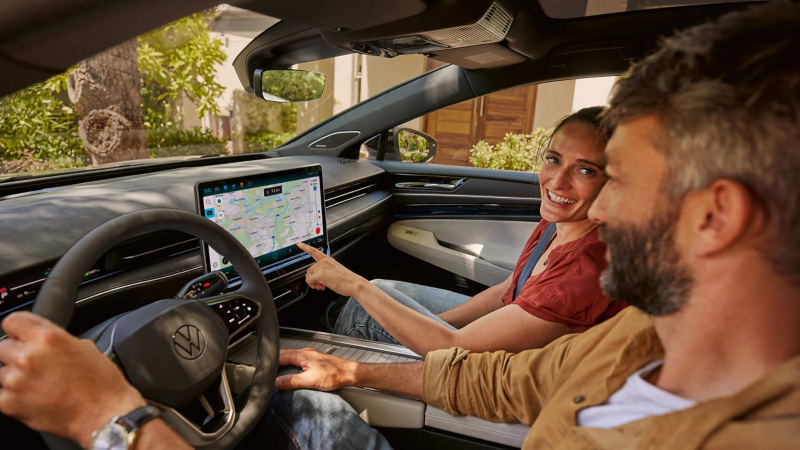 A man and woman checking a map whist sitting in a car