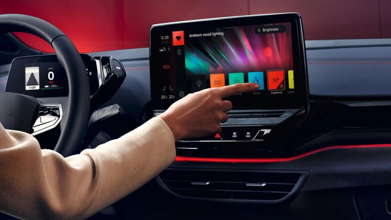 close up of an infotainment screen in a Volkswagen with a hand pressing the screen