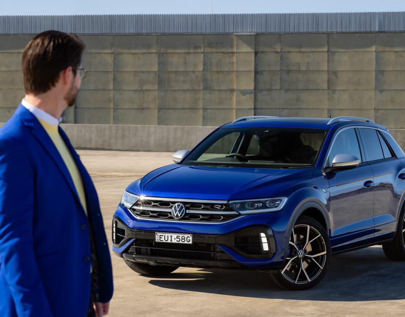 Man looking at the T-Roc R and walking towards camera.