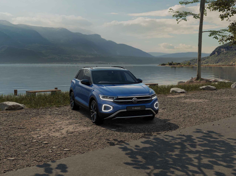 A blue VW T-Roc Style Design against a lake background