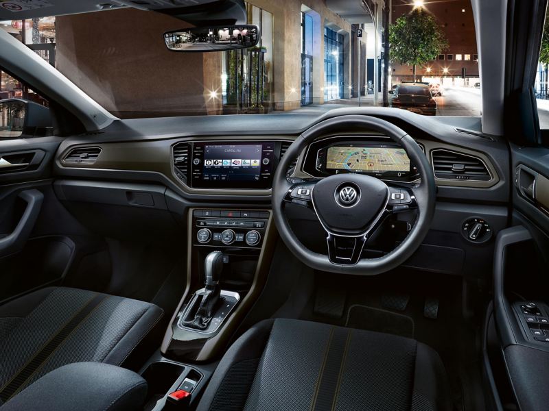 Interior shot of a Volkswagen, steering wheel and dashboard.