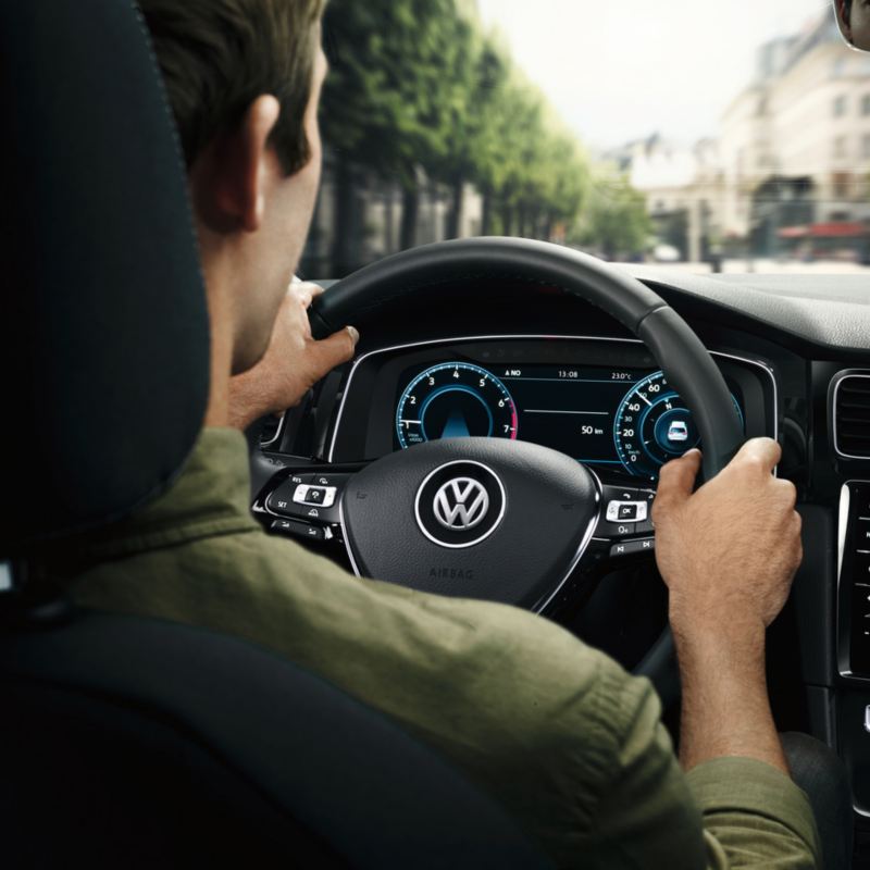 A man is getting in VW car on a driver’s seat, link out to VW test drive page