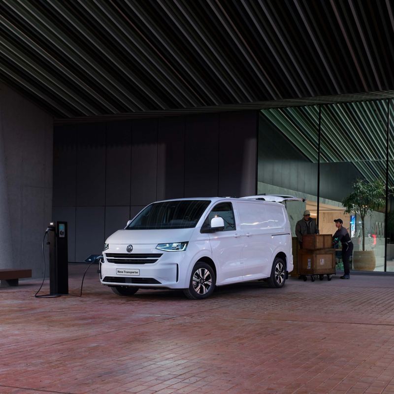 White VW Transporter parked against a urban background. 