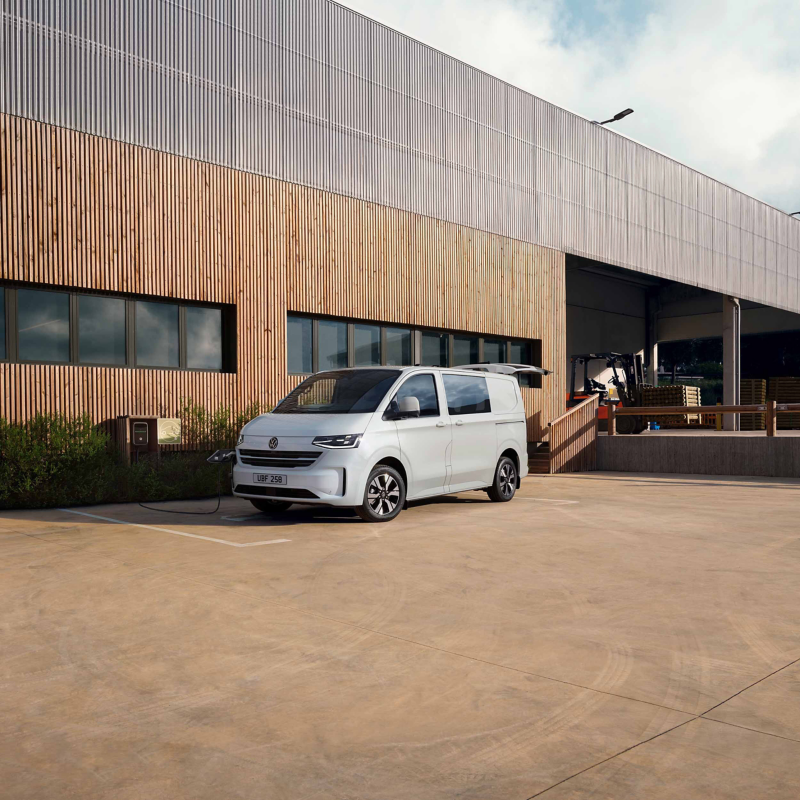 Photo showing a New Transporter Kombi parked outside out of a warehouse.